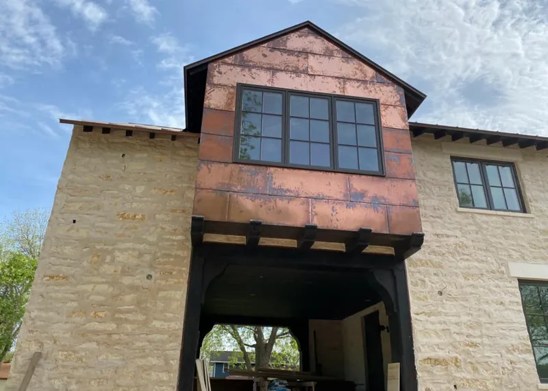 Copper metal panel facade on a stone building for Skylight Installation in Berthoud